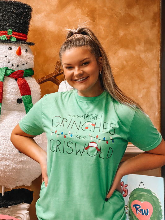 In a World Full of GRINCHES Be a GRISWOLD T-Shirt (Heather Green)